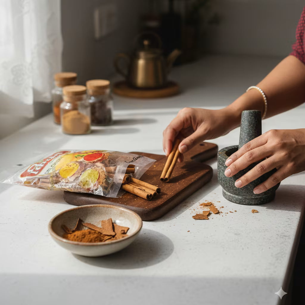 Person preparing spices on a kitchen counter with a mortar and pestle having Cinamom Dalchini Stick