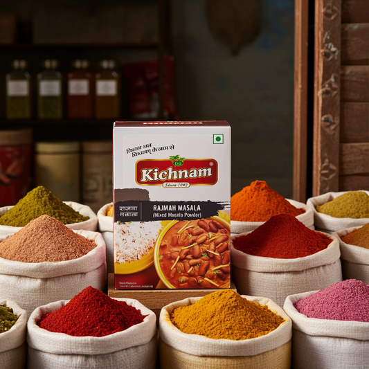 Kichnam brand Rajmah Masala box surrounded by various spices in small bowls.
