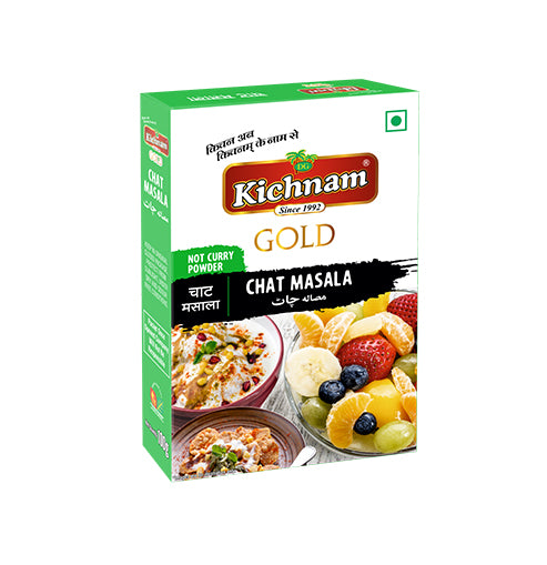 Angled green and white Kichnam Gold Chat Masala box with food.