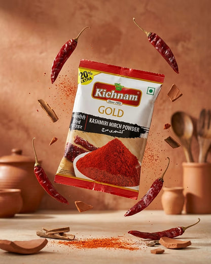 Kichnam Gold Kashmiri Mirch Powder package with red chili peppers and spices on a wooden surface.
