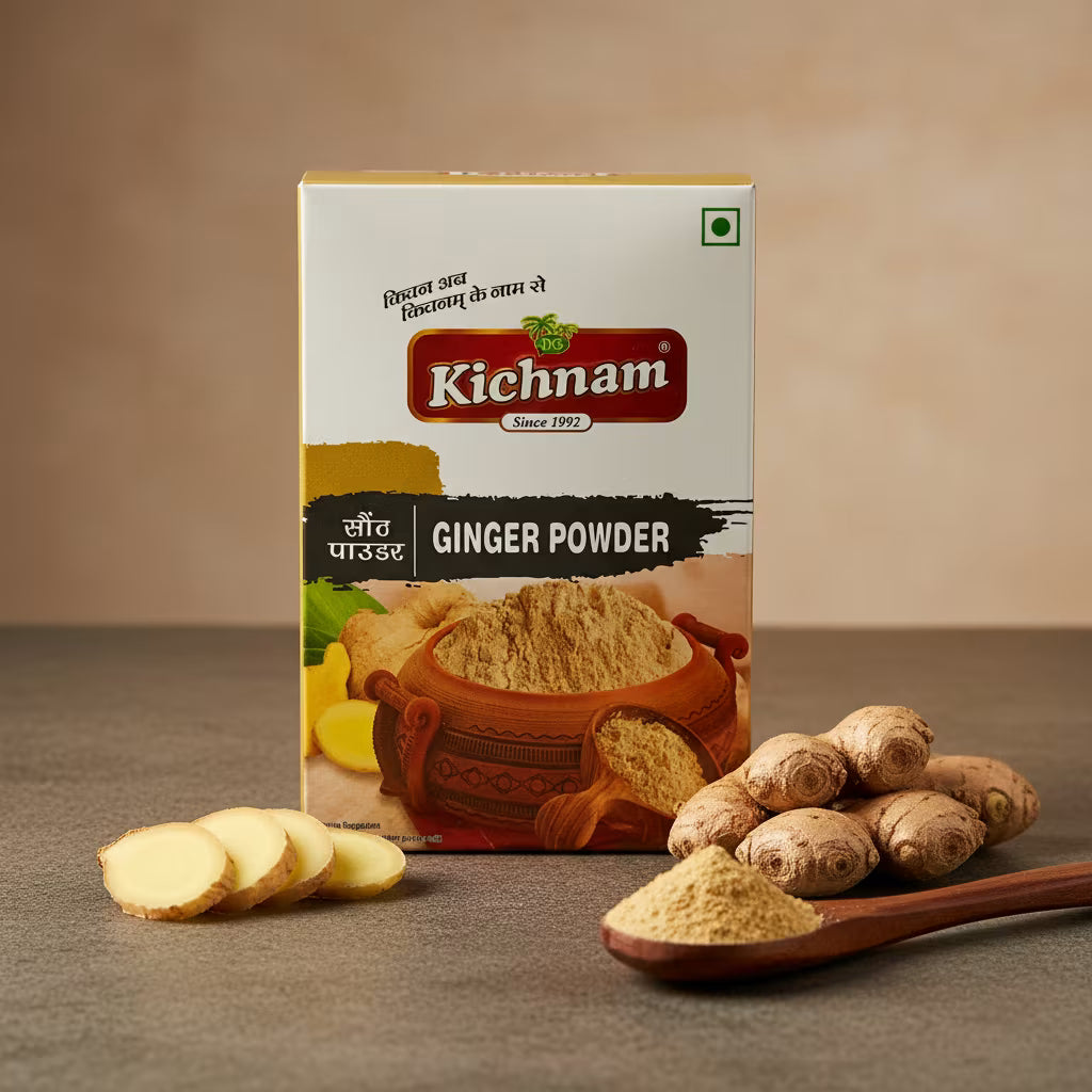 Kichnam ginger powder packaging with ginger slices, whole ginger, and a wooden spoon on a brown background