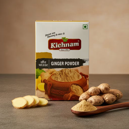 Kichnam ginger powder packaging with ginger slices, whole ginger, and a wooden spoon on a brown background