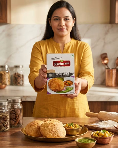 Woman holding a Kichnam product in a kitchen setting with food items on the table.