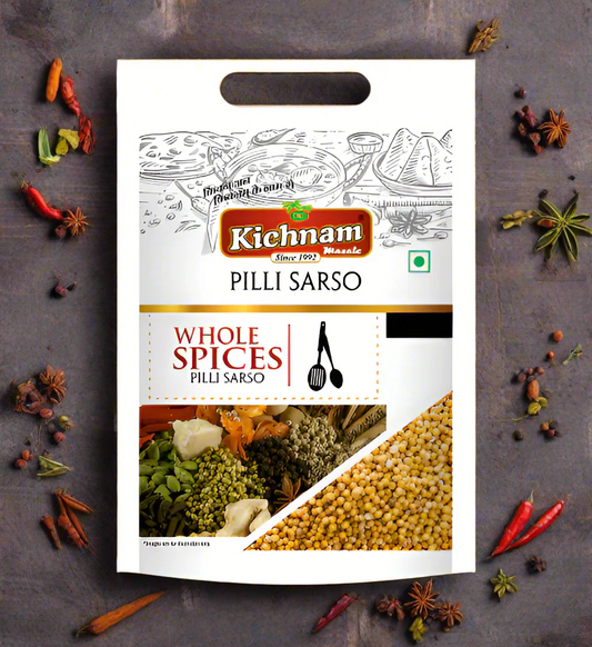 A package of Kichnam Pili Sarso Sabut, whole yellow mustard seeds, with a net weight of 100 grams, displayed on a background with various spices.