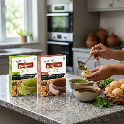 Kitchens Gold panipuri masala boxes on a kitchen counter with a person spooning food.