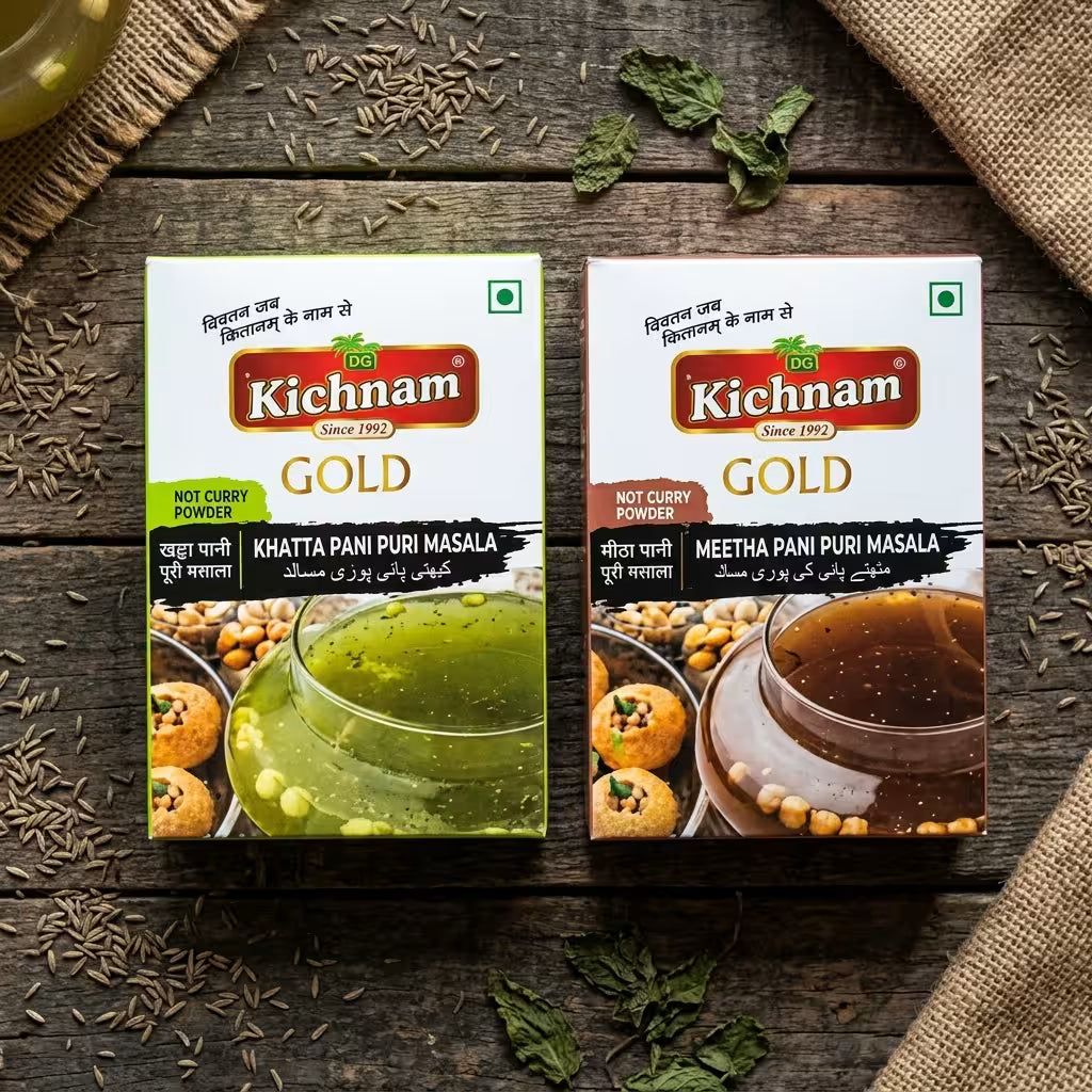 panipuri masala packs of  Two Kichnam Gold  on a wooden surface with ingredients around.