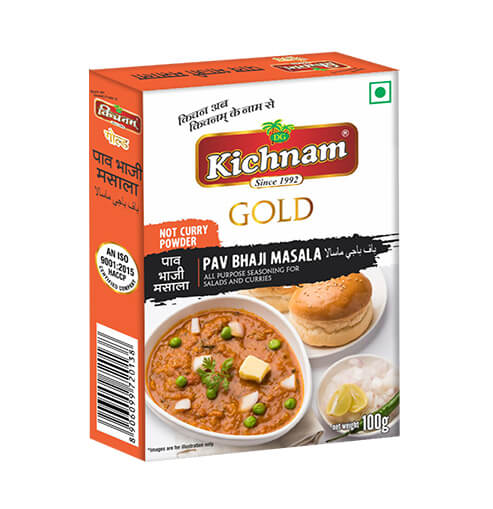 White and orange Kichnam Gold Pav Bhaji Masala 100g box with food.