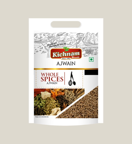 A white 100 gm pack of Kichnam Ajwain (Carom Seeds) shows Indian food illustrations, a see-through window with aromatic seeds, the brand logo on top, digestive benefits, and cooking utensil designs on the packaging.